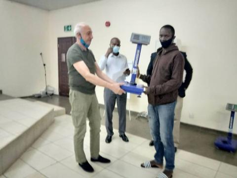 A CTC official presenting the measuring scale to one of the beneficiaries A CTC official presenting the measuring scale to one of the beneficiaries