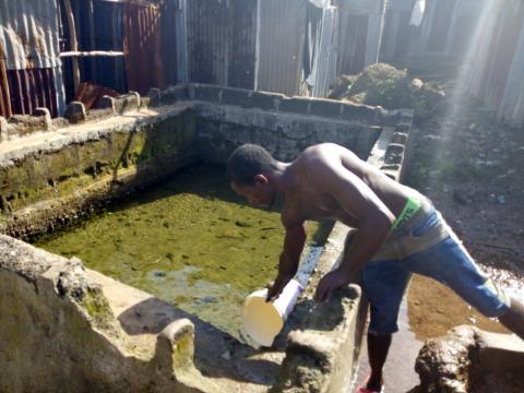 An algae infested reservoir where Docorty community people fetch their drinking water An algae infested reservoir where Docorty community people fetch their drinking water