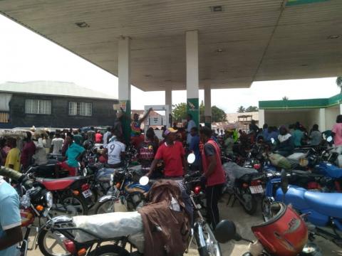 Bike riders scramble for fuel at an NP station in Bo Bike riders scramble for fuel at an NP station in Bo