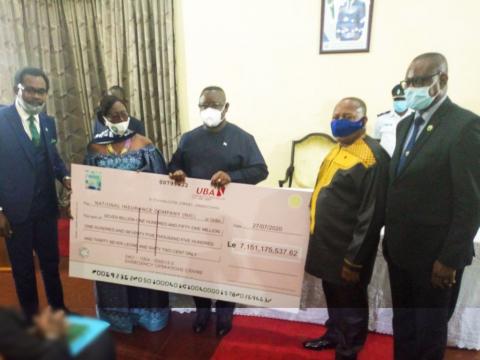 President Bio and NIC officials holding a cheque of the premium President Bio and NIC officials holding a cheque of the premium