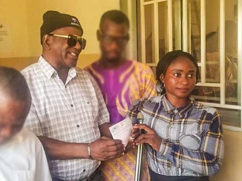 Chairman of the Disability Commission handing over a cheque to one of the beneficiaries Chairman of the Disability Commission handing over a cheque to one of the beneficiaries