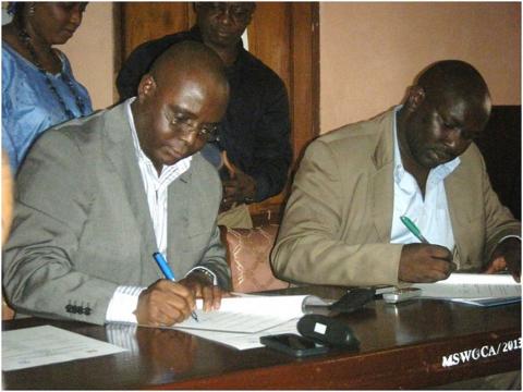 Country Director Plan and Minister signing the MOU Country Director Plan and Minister signing the MOU