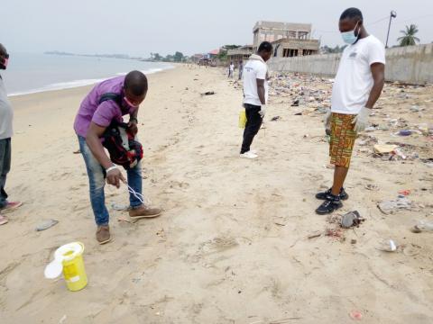 SLYDCL field officers collect needles and syringes along Levuma Beach in the west end of Freetown SLYDCL field officers collect needles and syringes along Levuma Beach in the west end of Freetown