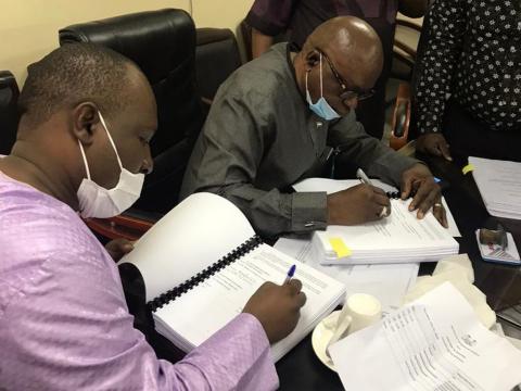 Transport Minister Kabineh Kallon signing contrcat with a representative of PAVIFORT Transport Minister Kabineh Kallon signing contrcat with a representative of PAVIFORT