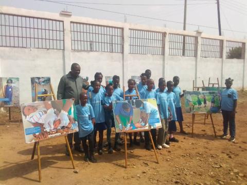 children displaying their drawings. children displaying their drawings.
